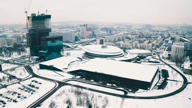 Katowice, Poland snowy winter cityscape drone panorama: modern urban business city center with Spodek sports music hall, KTW office skyscrapers construction and Centrum Kongresowe in Silesia capital