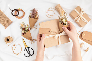Gift boxes in craft paper and natural decorations, creative and recyclable holidays present wrapping