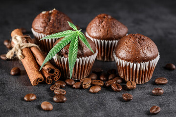 Cupcake with marijuana.traditional sponge cake with cannabis weed cbd. Medical marijuana drugs in food dessert, ganja legalization.Stack of chocolate slices with mint leaf on a wooden table.
