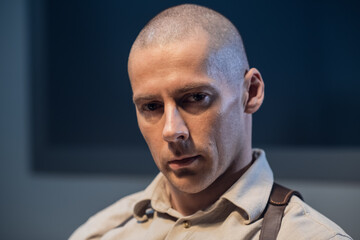 An experienced police officer poses for a photo at a police station.