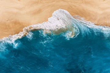 Fotobehang Blue ocean and clean sandy beach. Beautiful sea and wild beach with yellow sand. Blue ocean wave on a sandy beach. Top view of the tropical beach. Paradise island. Copy space © MISHA