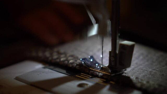 On a sewing machine sew clothes close-up. 