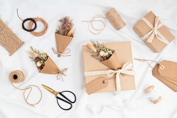 Fototapeta na wymiar Gift boxes in craft paper and natural decorations, creative and recyclable holidays present wrapping