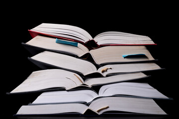 A stack of books on the desk. Old extensive literary publications.