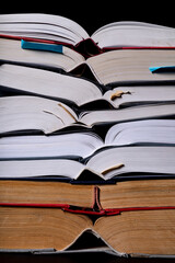 A stack of books on the desk. Old extensive literary publications.