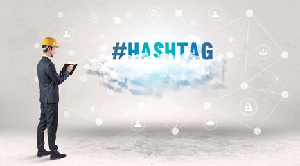 Engineer working on a social media concept with #HASHTAG inscription