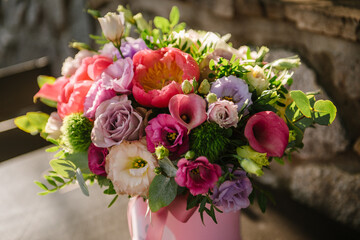 girl holding beautiful mix flower bouquet in round box