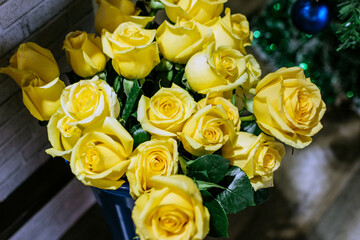 Bouquet of yellow roses in the New Year's interior