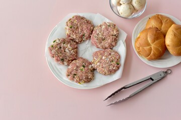 Ingredients ready for preparing homemade hamburgers for summer grilling and picnics. Photo concept food, background, lifestyle. Flat lay copy space. 