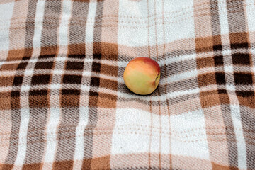 Apple on a beige plaid close up