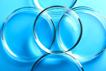 Abstract medical cosmetology blue background from glass petri dishes.