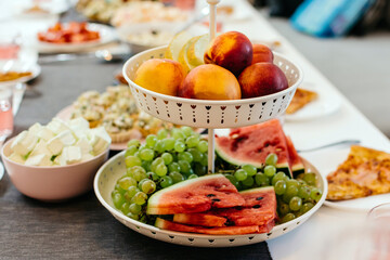 Plate with different fruits on the festive table horizontal