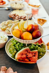 Plate with different fruits on the festive table vertical