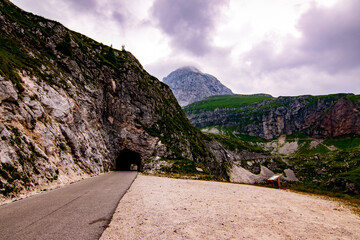 Fototapeta na wymiar Julian Alpes tunnel on the way to Mangart mountain, which itself is visible in the distance, Slovenia