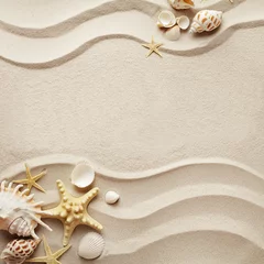 Fotobehang summer concept: sandy beach background with seashells. copy space for text © KMNPhoto