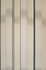 Parallel vertical metallic white stripes