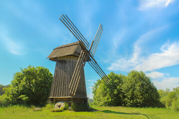 Windmill. Rural nature landscape with old wooden mill. © Elena
