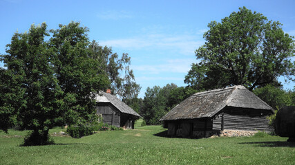 Fototapeta na wymiar Ergli region, land of Latvia in Europe. Ancient rustic buildings architecture landscape in a summer season. A traditional homestead in a cultural and historical place in the Latvian countryside.