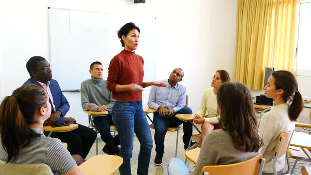 Female teacher is giving lecture for students in the class. High quality 4k footage
