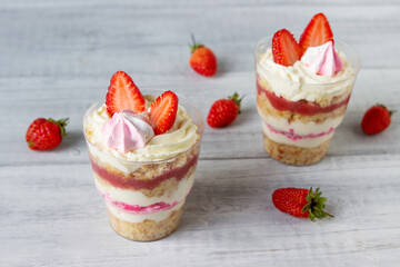 Delicious dessert in a glass, with strawberry jelly, cream and  fresh strawberrys.