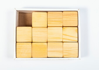 The box contains wooden cubes, one is missing