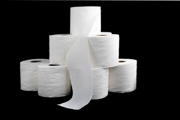 a pile of toilet paper rolls isolated on black