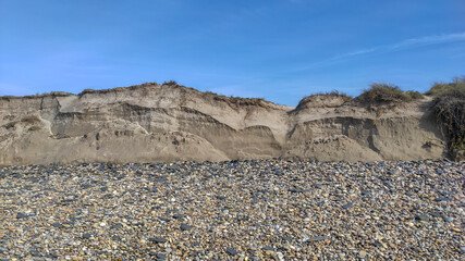 Post-storm eroded dune in Esposende, Portugal. Sand loss from a dune under wave attack.