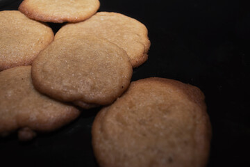 Fresh homemade cinnamon and sugar cookies on a black plate