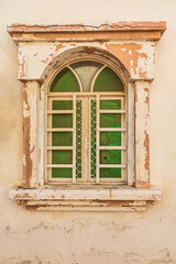 Fototapeta na wymiar Green shuttered window on a building in Oman.