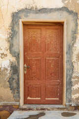 Carved wooden door on a building in Oman.