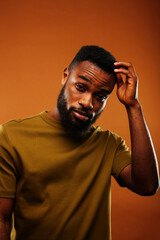 young pretty african american man posing cheerful on brown background, lifestyle people concept