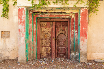 Fototapeta na wymiar Old carved wooden door on a building in Oman.