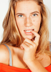 young cute blonde girl posing emotional on white background isolated, lifestyle people concept