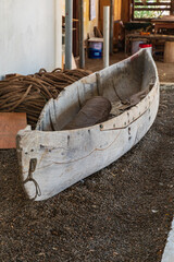 A small wooden dogout canoe.