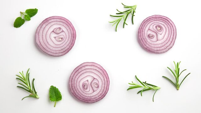composition of fresh red onion slices and various spices on white background, top view, stop motion animation