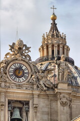 Clock on facade of Saint Peter basilica in Rome, Italy