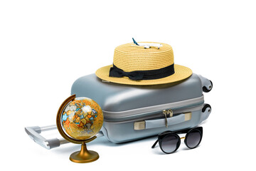 Summer time. Travel accessories with suitcase, straw hat, toy airplane and globe in minimal trip vacation concept isolated on white background. Exotic tropical beach with copy space.