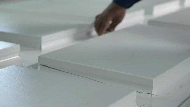Closeup Of Wood Wrapped With Vinyl PVC Is Cut And Removed From Industrial Press Machine