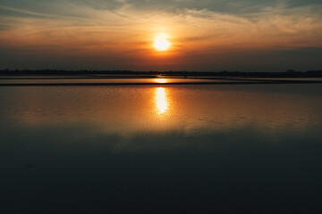 Fototapeta na wymiar Colorful sunset landscape view of salt farm or salt pan in Thailand.