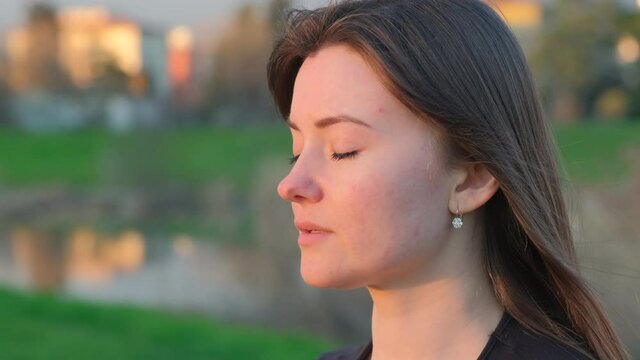 Relaxation in the morning at sunrise. Calm concept. Closeup of caucasian girl