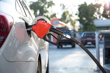 Pumping gasoline fuel in car at gas station ,price gasoline concept.