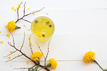 herbal healthy drinks cold chrysanthemum flowers cocktail water beverage for health care with yellow flowers marigold local flora of asia arrangement flat lay style on background white wooden