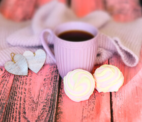 Cozy stiil life with cup of coffee, warm plaid,  hearts and marshmallow. pink wooden background. Haze vintage filter and soft focus. Happy Valentine's Day