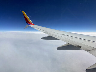 Airplane Wing Flying in the Clouds