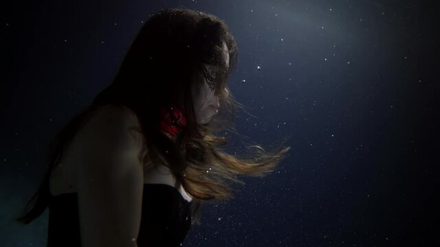 sexy woman underwater, mysterious lace mask on face, fairy tail lady is floating in darkness of ocean or sea
