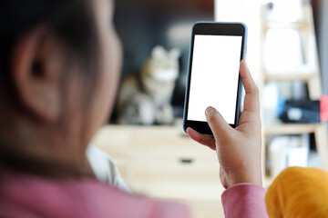 Close up view of male hands using smart phone with modern office blurred background. Blank screen monitor for graphic display montage.