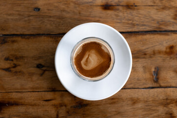 cup of dirty coffee on wooden table, top view