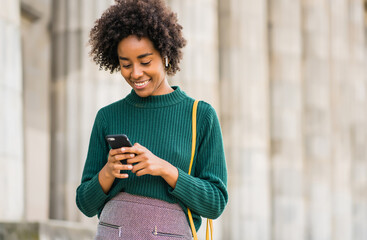 Business woman using her mobile phone outdoors.