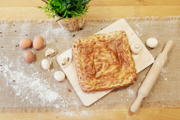 Pie on a chopping board. The food is ready to eat. Puff Pastry pastry