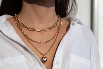 Poster Beautiful model brunette in modern gold metal necklace chain © Тимур Конев
